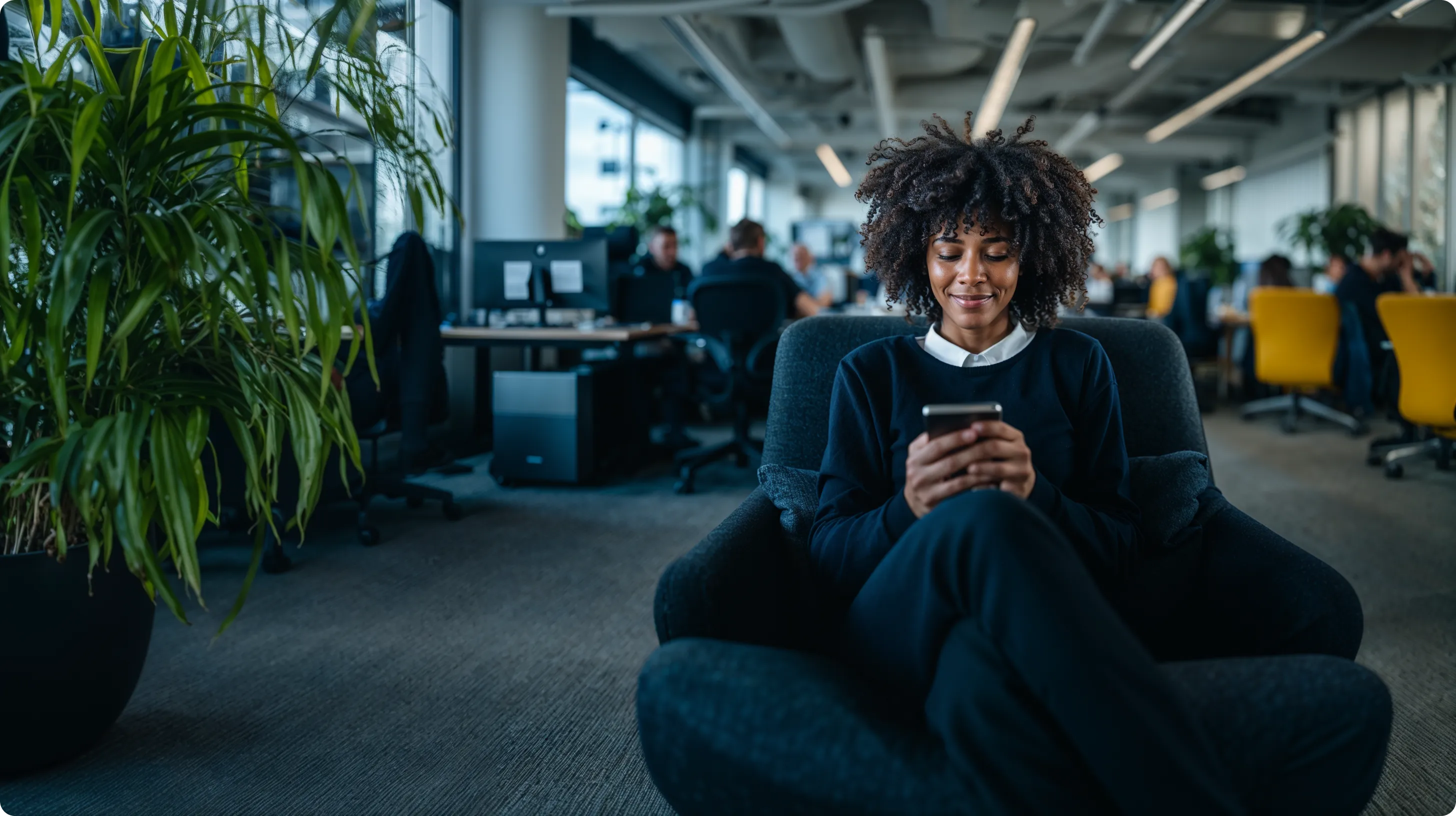 Person using a smartphone in a modern office