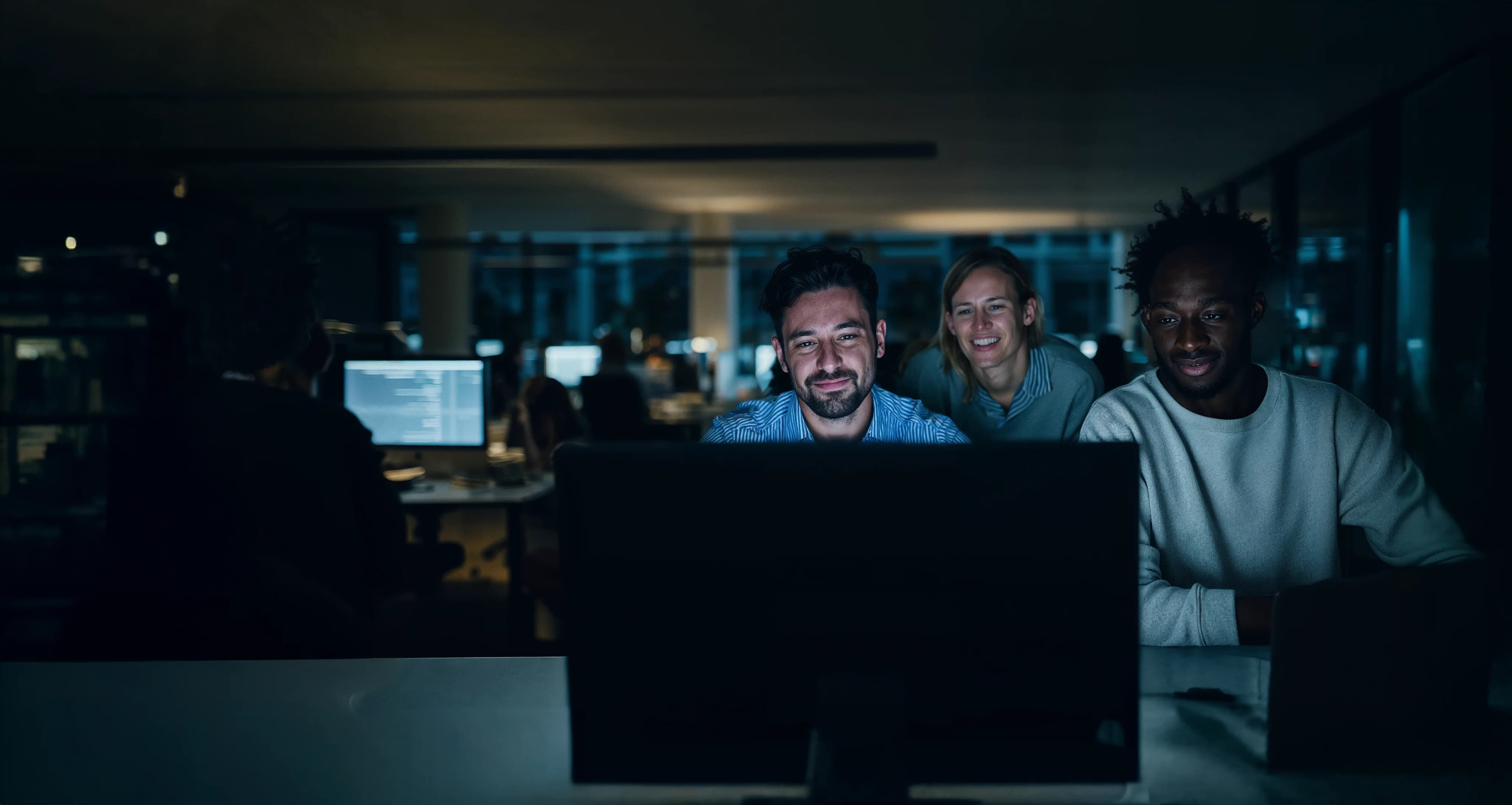 Colleagues reviewing benefits information together at a screen